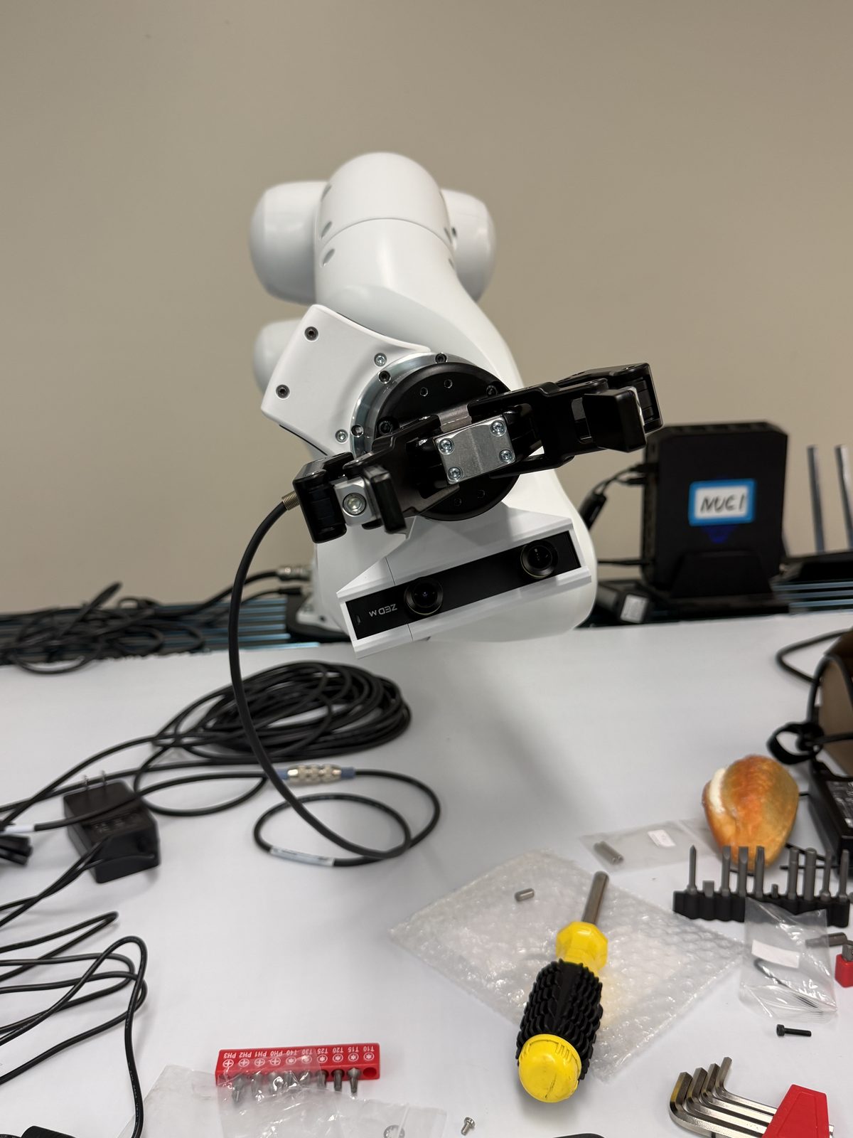 Robotiq gripper and wrist-mounted camera on the FR3 end-effector